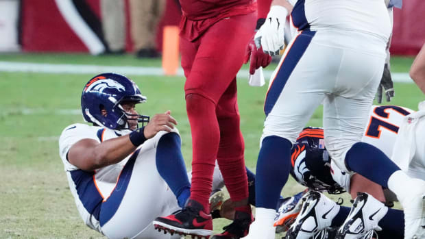 Arizona Cardinals linebacker Jesse Luketa (43) reacts after sacking Denver Broncos quarterback Russell Wilson (3) during a preseason game at State Farm Stadium in Glendale on Aug. 11, 2023